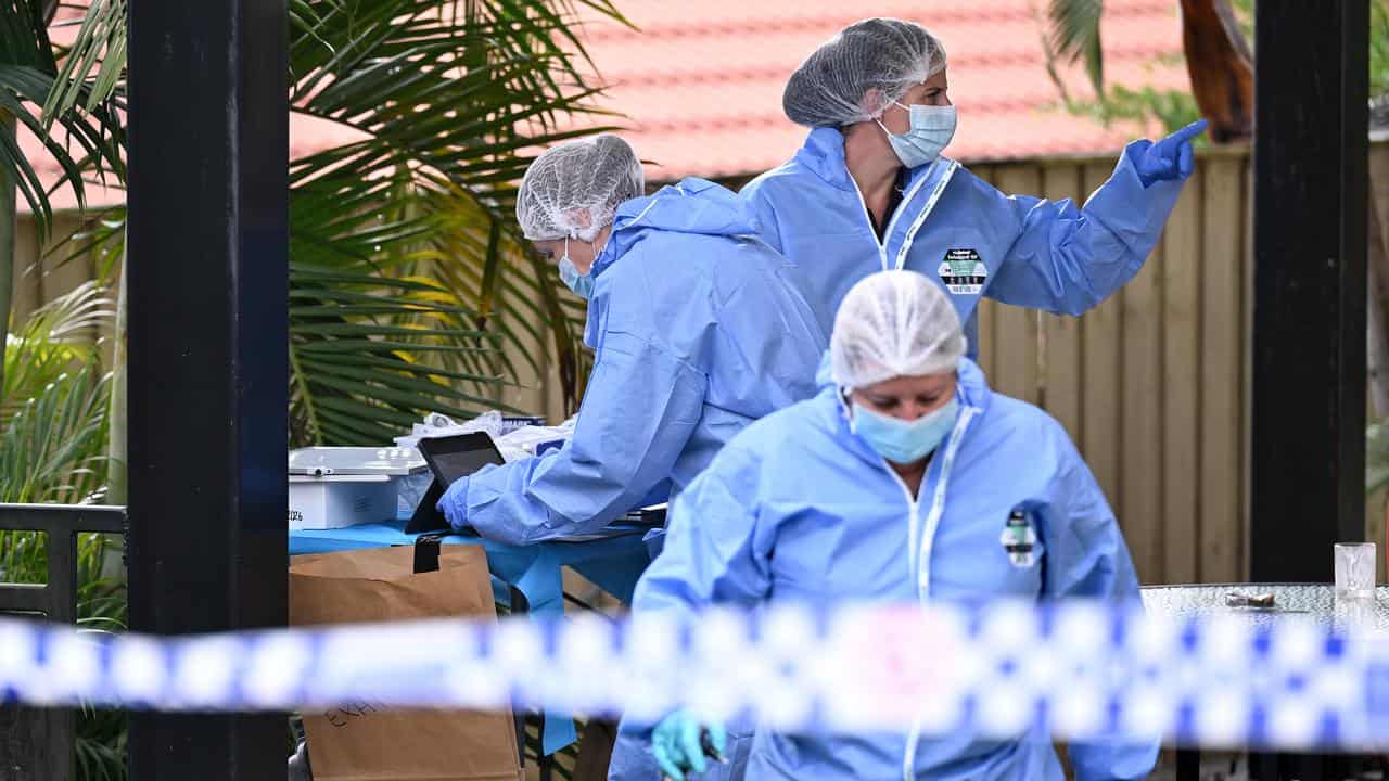 Forensic police work at a Springfield Lakes home where a woman died
