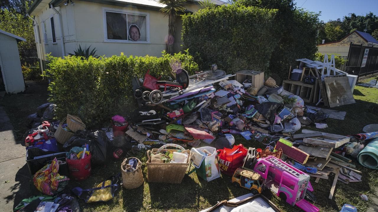 Local residents are seen cleaning up after floods in Taree