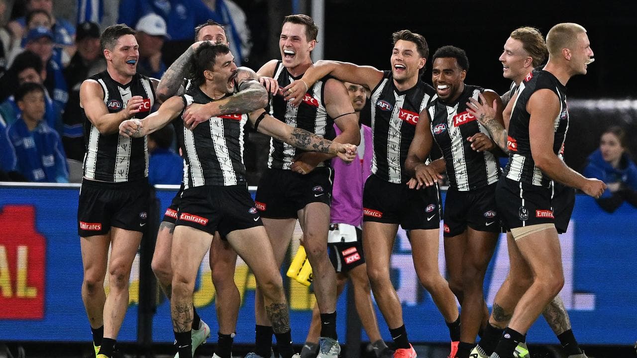 Oleg Markov of Collingwood (2nd left) celebrates with team mates