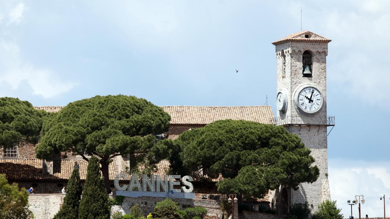 Stopped clock tower during a blackout in Cannes, France