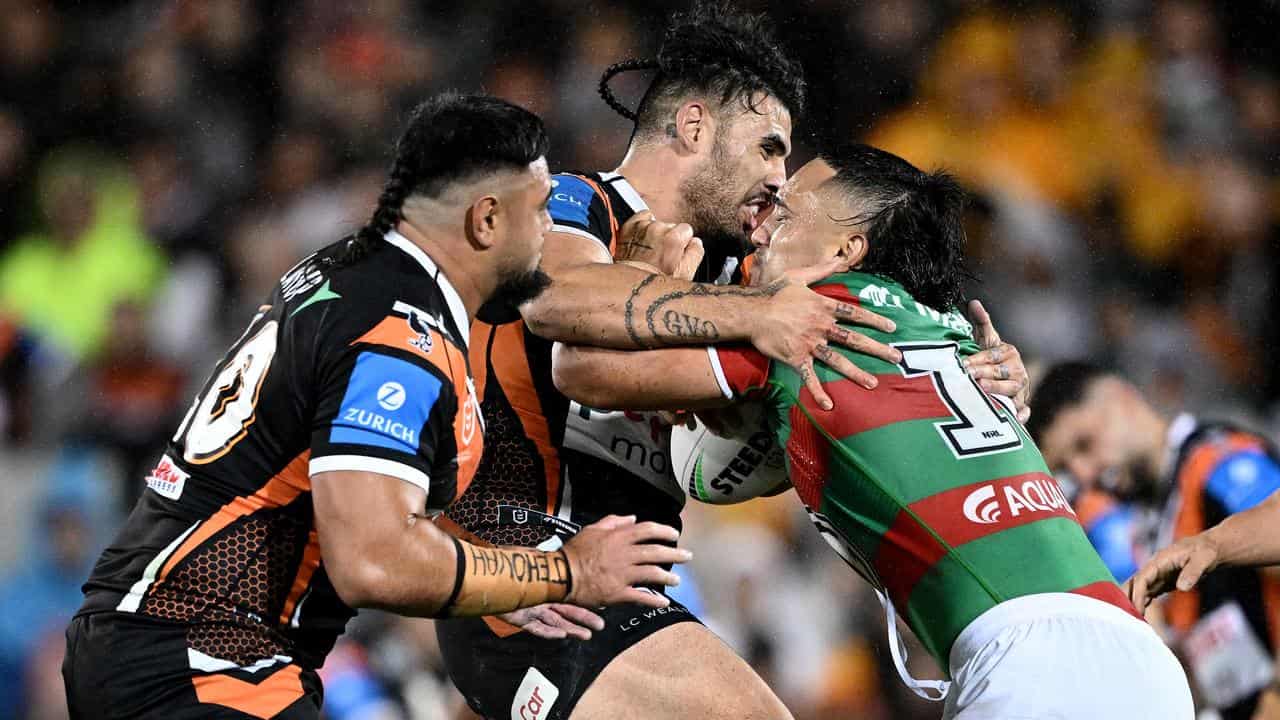 Keaon Koloamatangi (right) is tackled by Wests Tigers' Terrell May