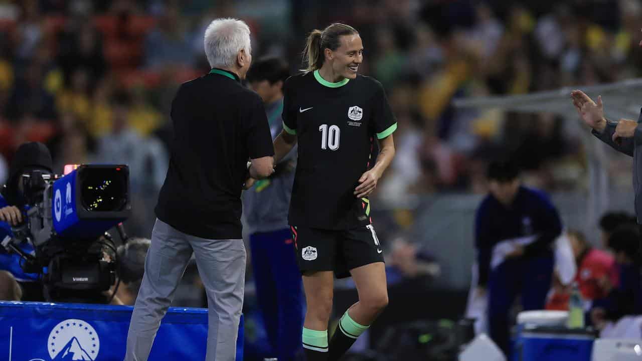 Tom Sermanni and Emily van Egmond.