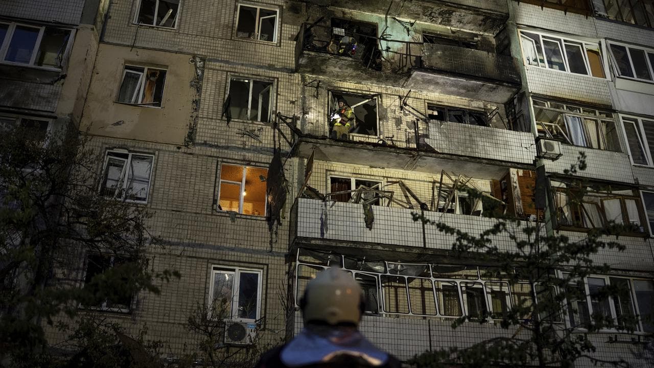 Emergency workers at an apartment block damaged by a Russian strike