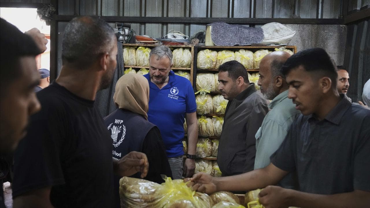 Palestinians bake bread after the World Food Program provided flour