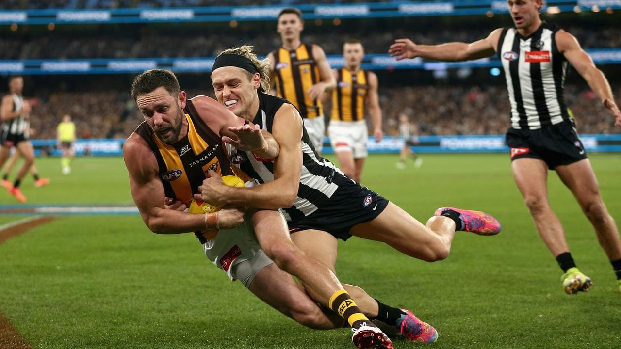 Jack Gunston is tackled by Darcy Moore.