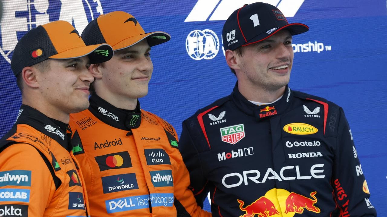Oscar Piastri (c) celebrates his Spanish GP pole.