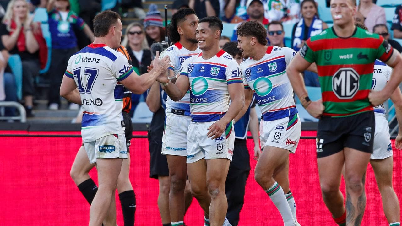 Roger Tuivasa-Sheck celebrates with teammates after scoring.