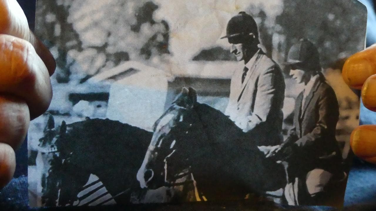 Black and white photo of John Kinghorn horse riding.