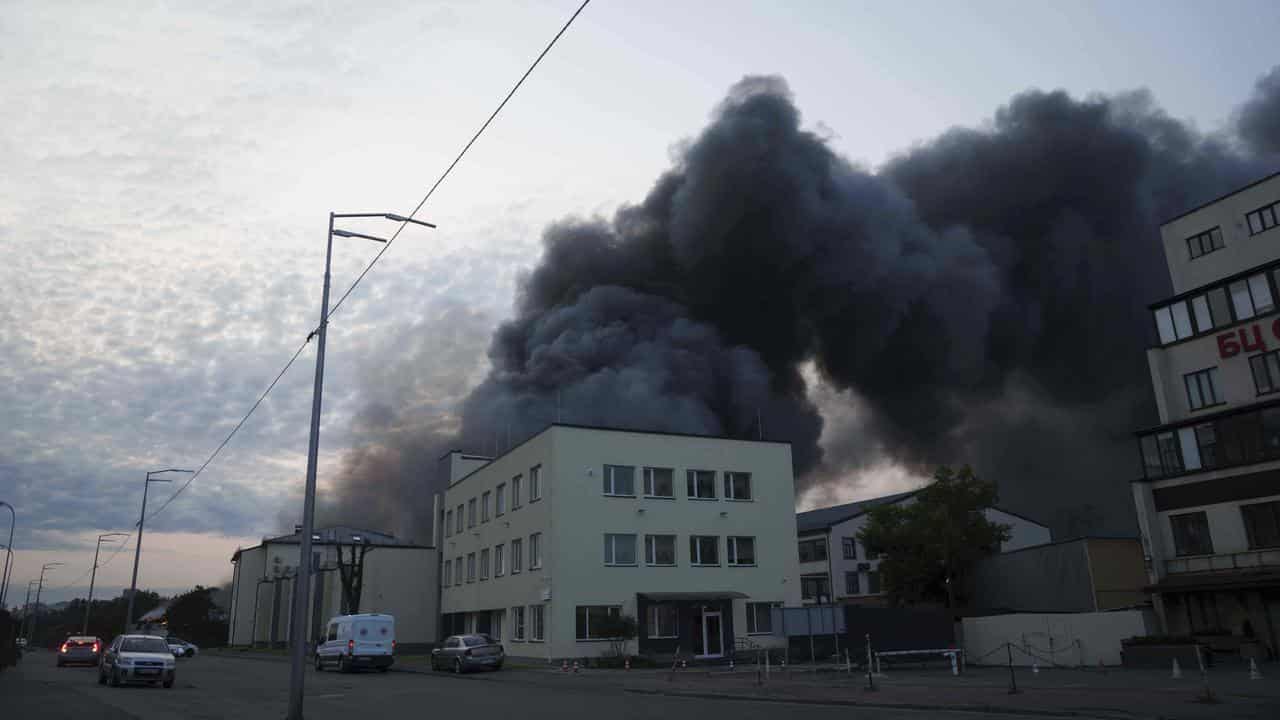 Smoke rises above a building destroyed by a Russian strike on Kyiv