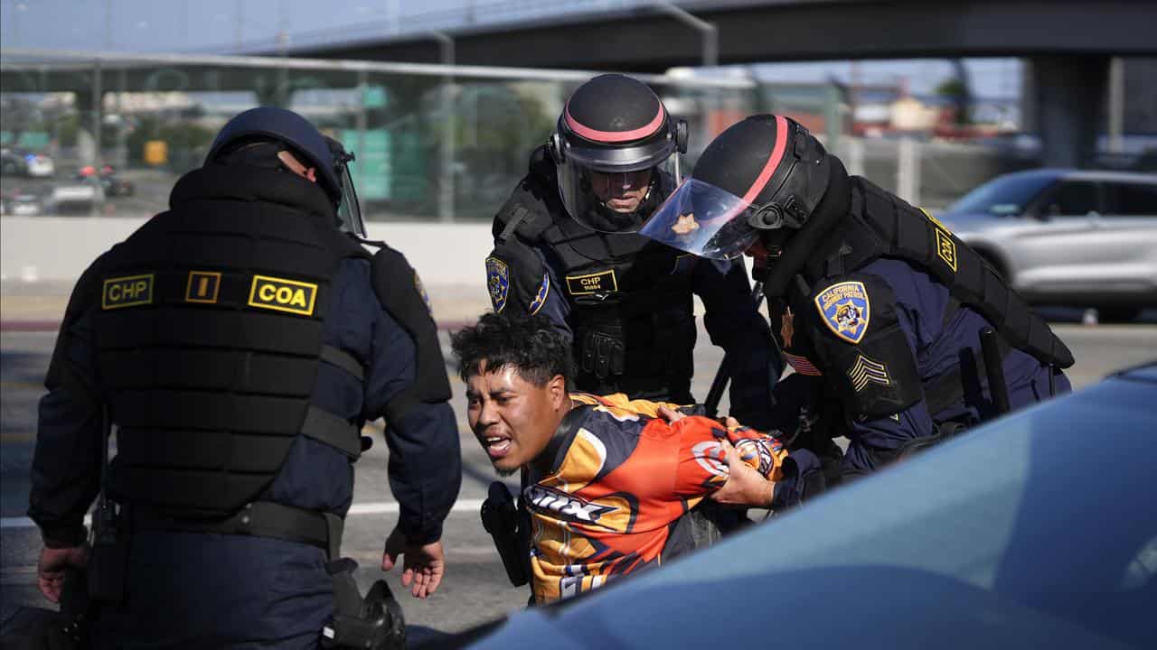 A protester is arrested by California Highway Patrol