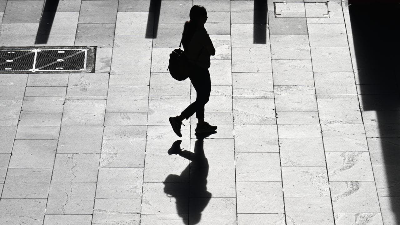  A silhouette of a woman walking