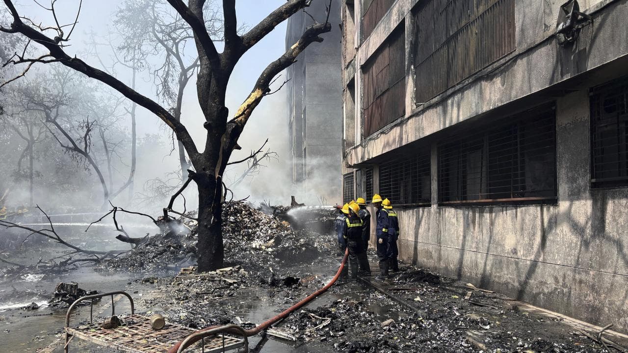Firefighters at the site of a plane crash in Ahmedabad