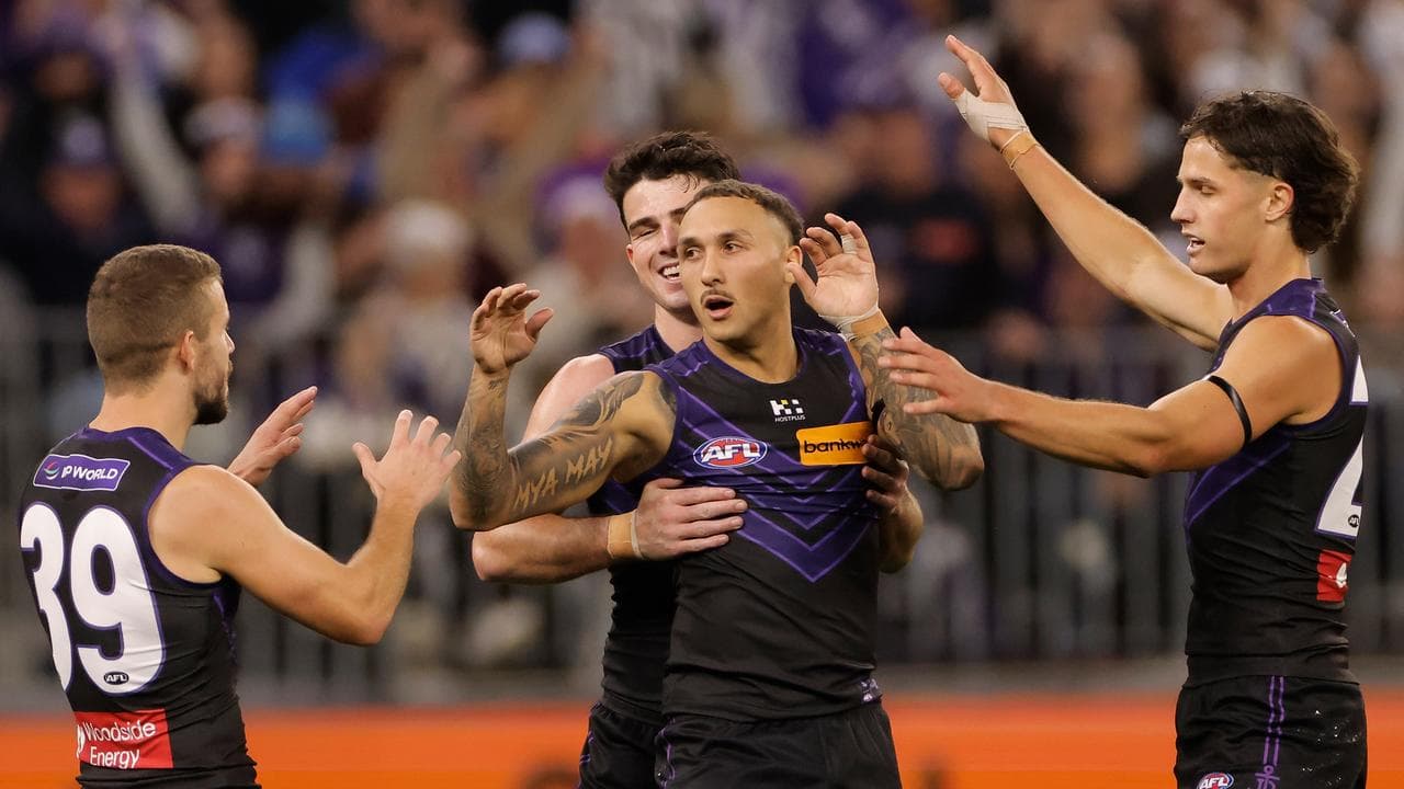 Shai Bolton of the Dockers is congratulated by teammates