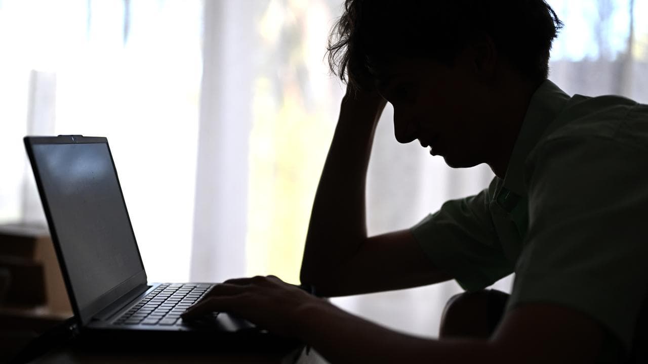 A silhouette of a male high school student