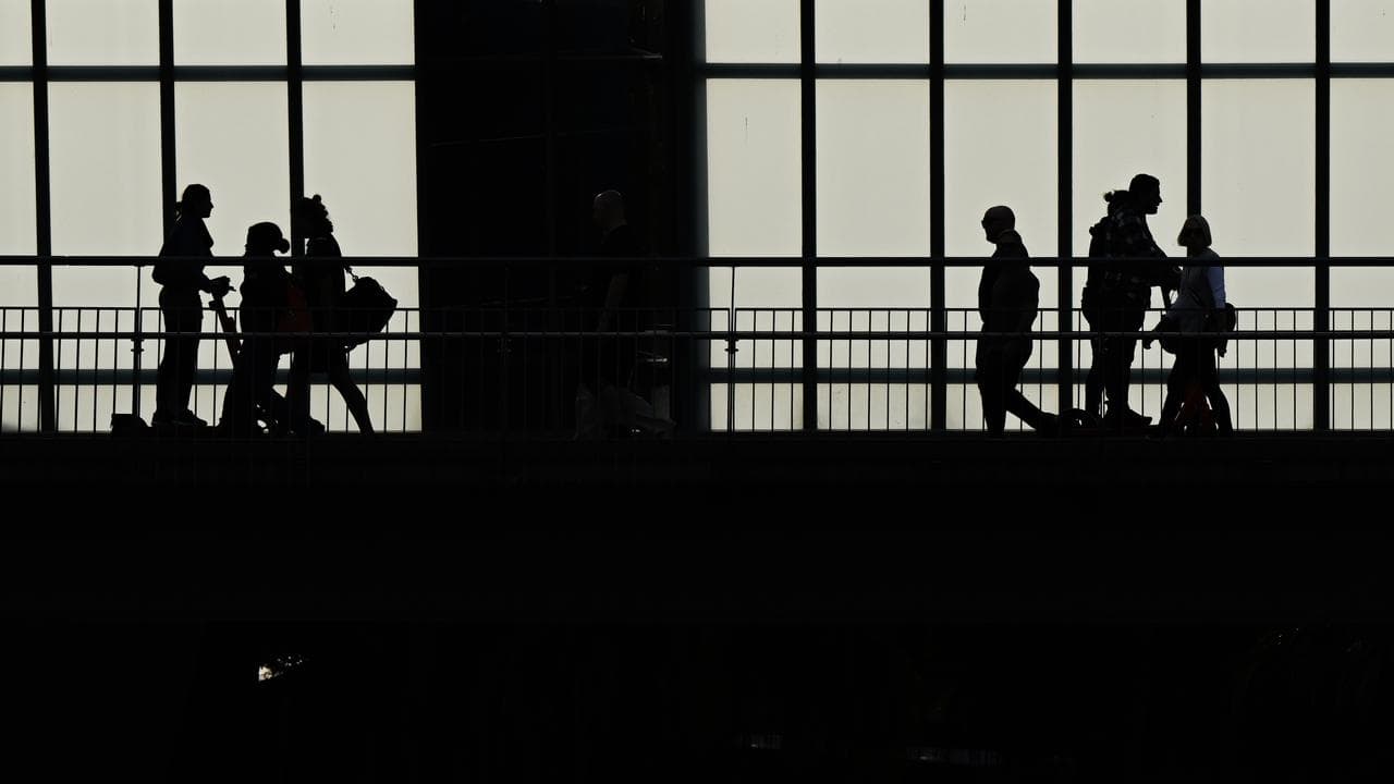 Pedestrians and people on scooters crossing the Goodwill Bridge