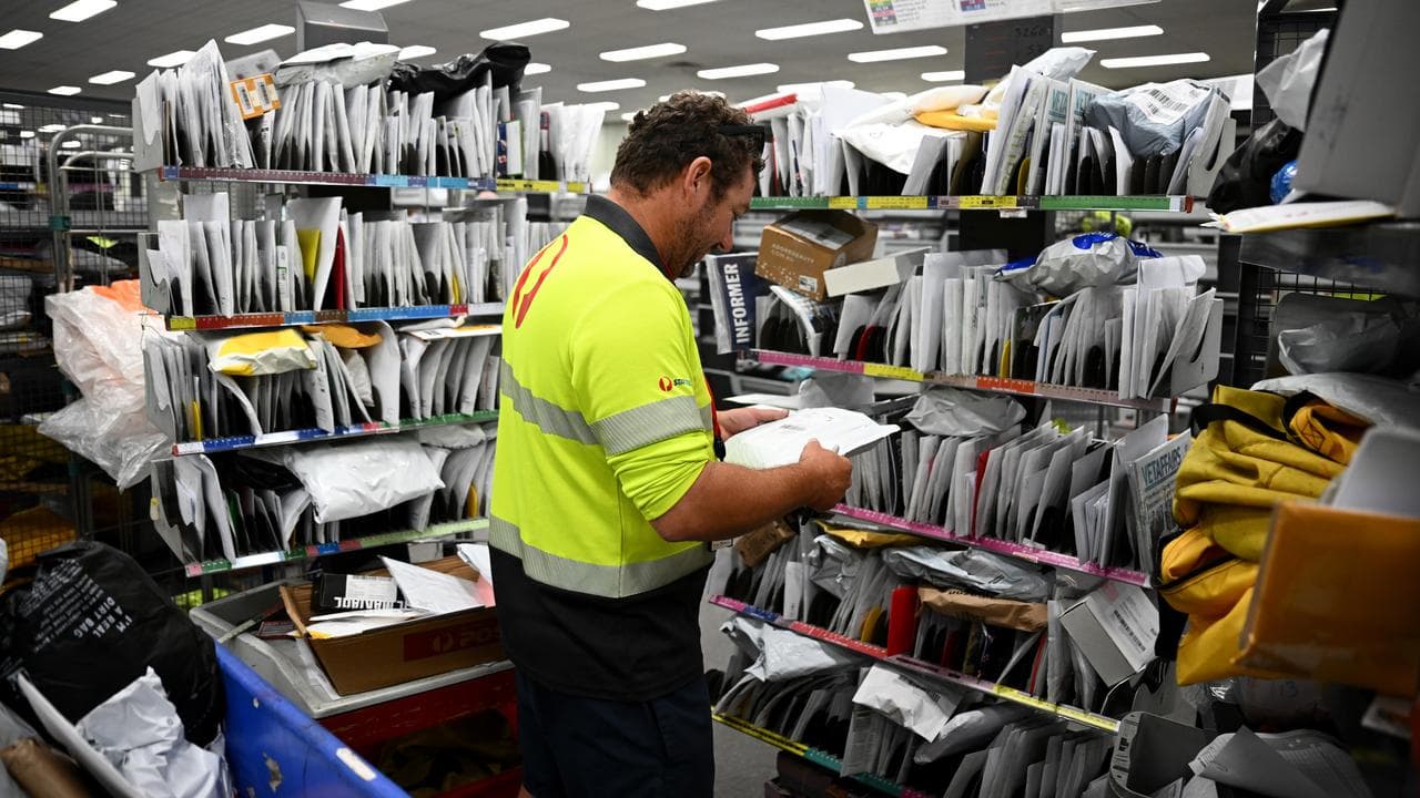 Australia Post workers sorting mail (file image)