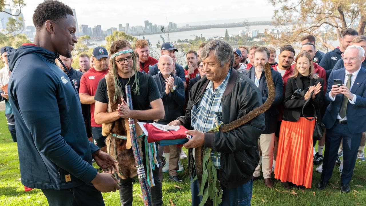 Lions captain Maro Itoje gives a gift to Uncle Trevor Walley.