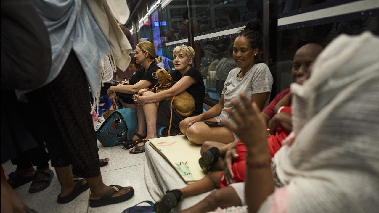 People take shelter during Iranian strikes in Ramat Gan, Israel