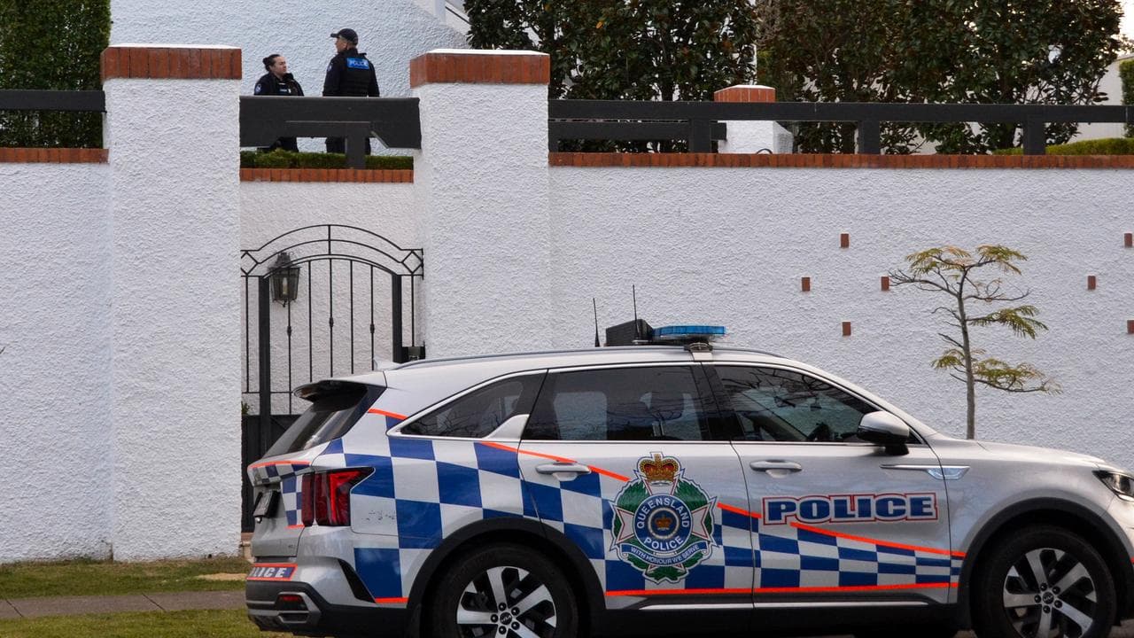 Police are seen at a house in Clayfield