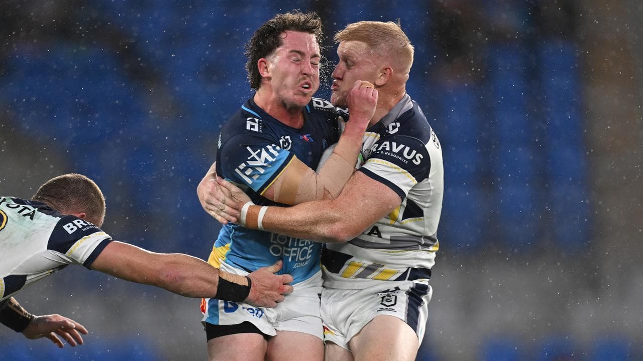 Cowboy Sam McIntyre lays a crunching tackle on Tom Weave.
