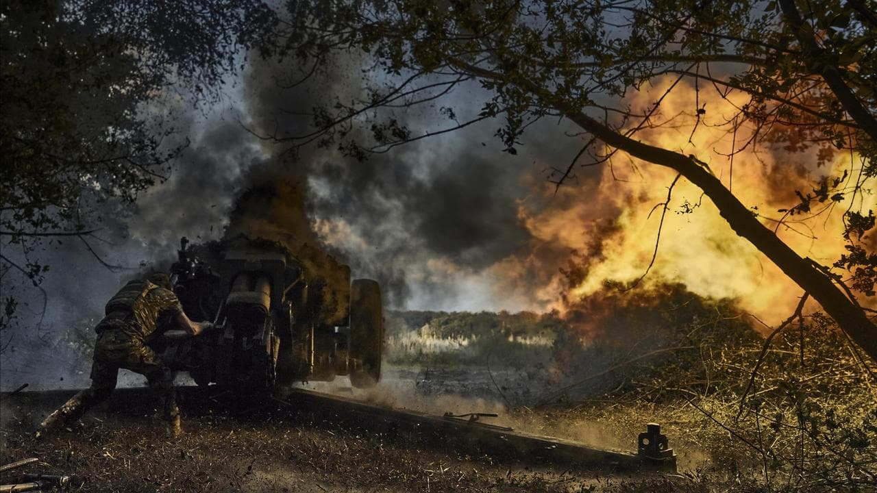 A Ukrainian policeman of special police unit fires a D-30 cannon