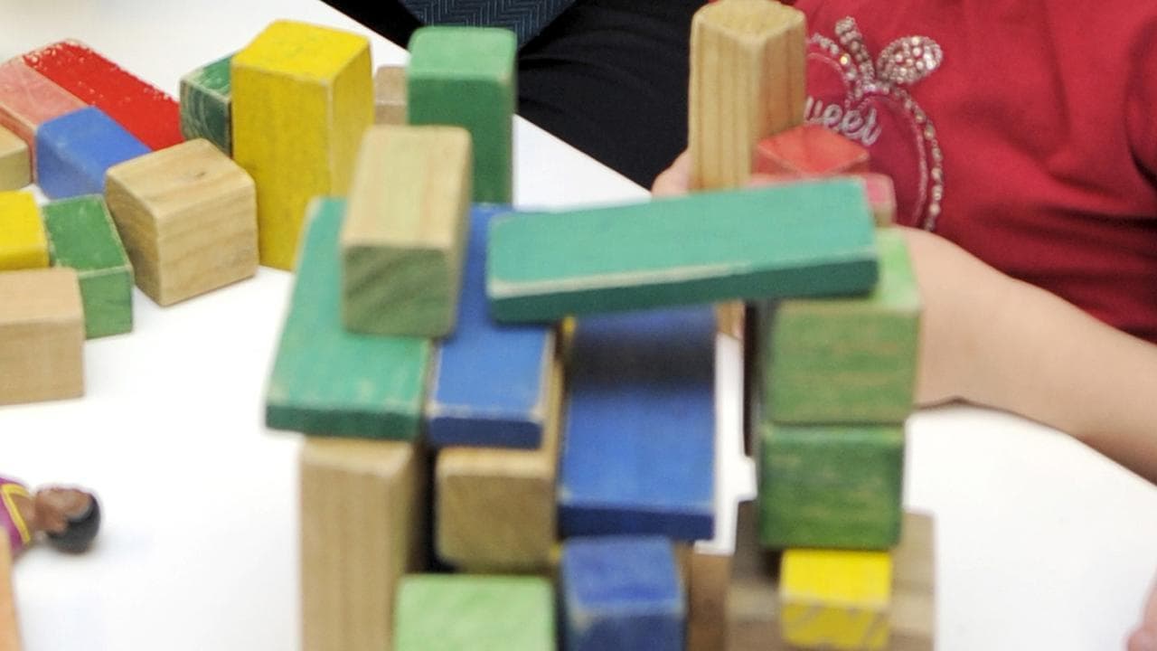 Child plays with toys at a preschool.
