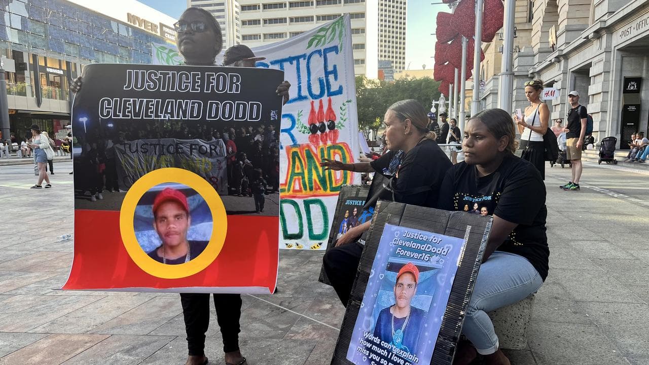 People hold signs of Cleveland Dodd