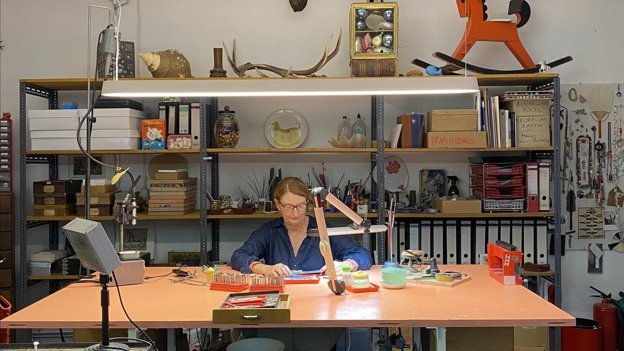 Helen Britton works at her desk in her studio in Munich, Germany