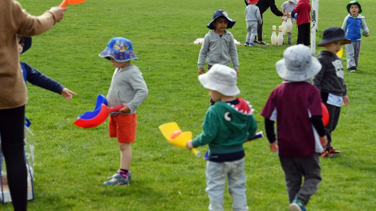 Group of children playing outside with staff