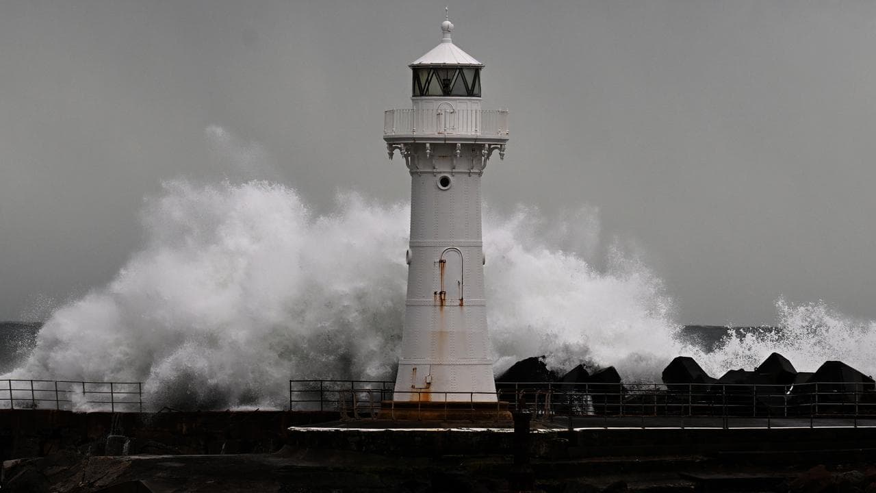 Waves batter seawall and lighthouse at Wollongong Harbour (file image)
