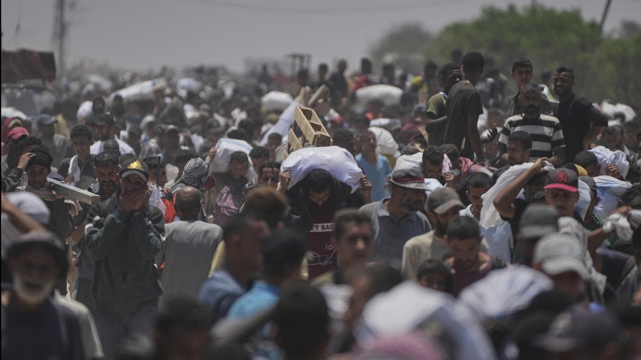 Palestinians carry food and aid in Rafah, Gaza Strip