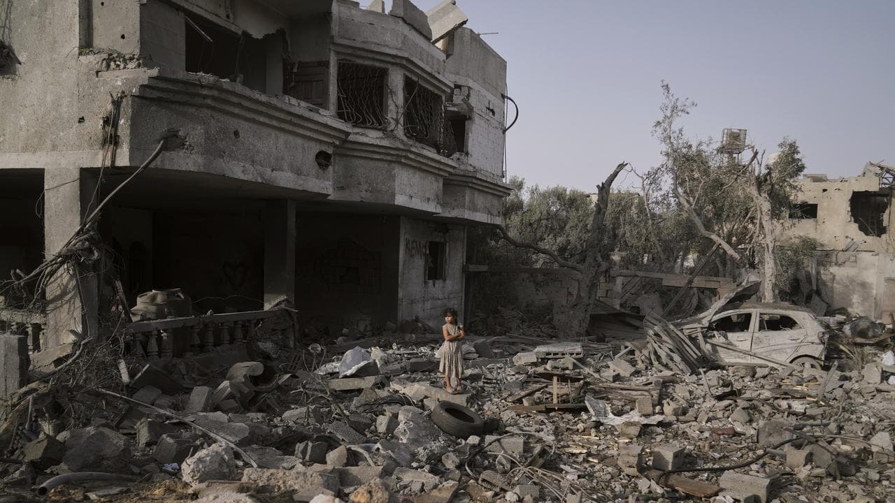 Palestinian girls stands in rubble in Gaza