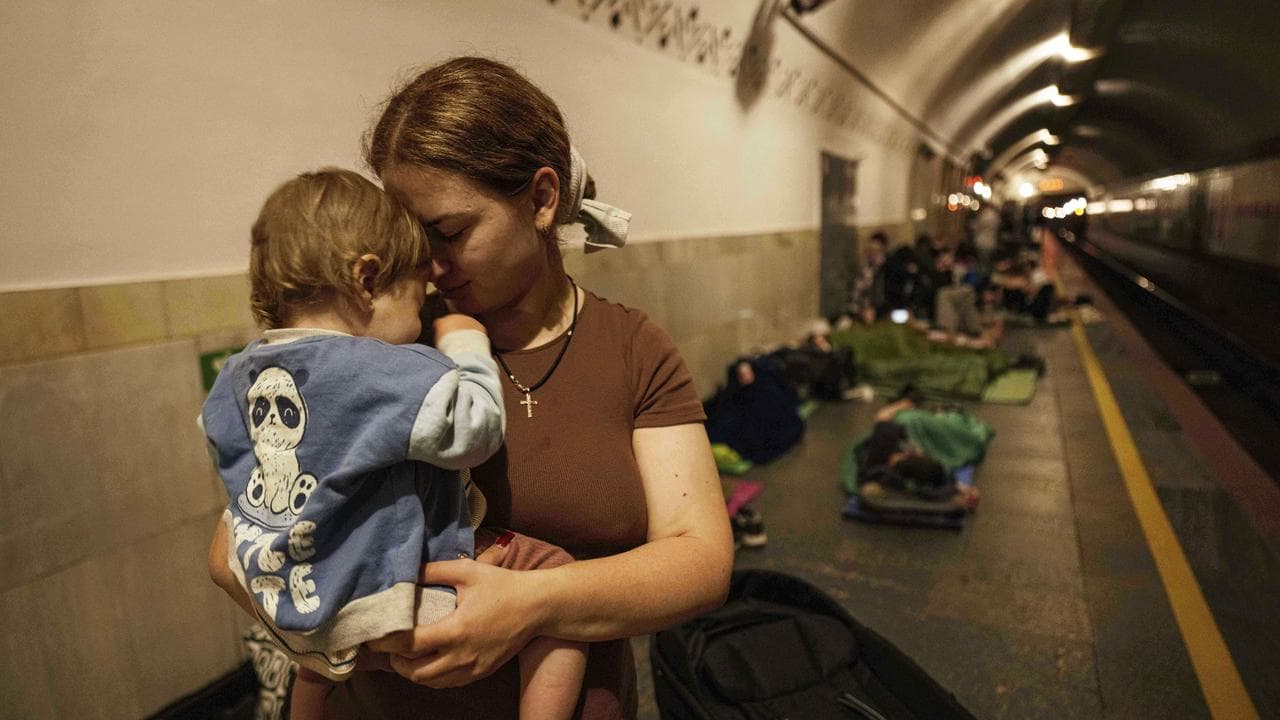 Mother calms her son at a metro station in Kyiv, Ukraine