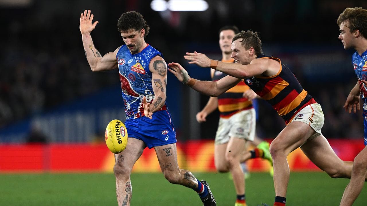 Jordan Dawson (right) tackles Tom Liberatore
