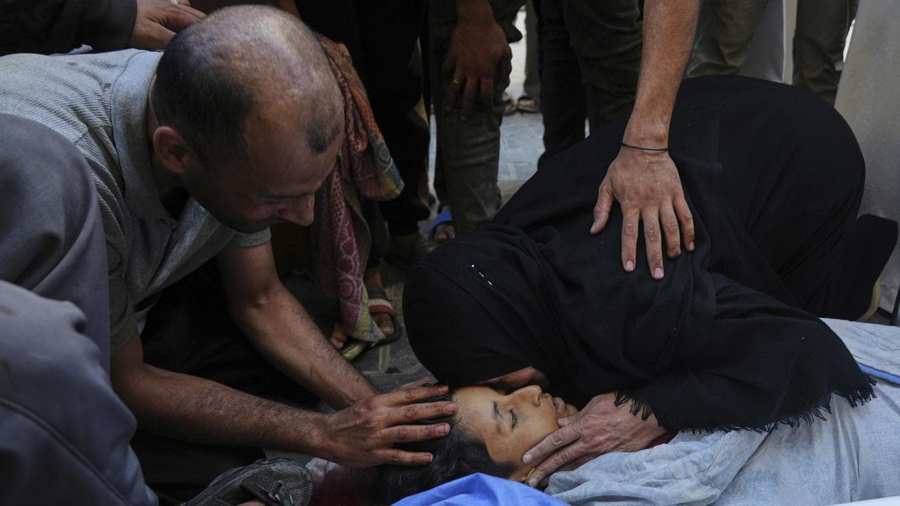 Relatives mourn over the body of 13-year-old Seraje Ebrahim