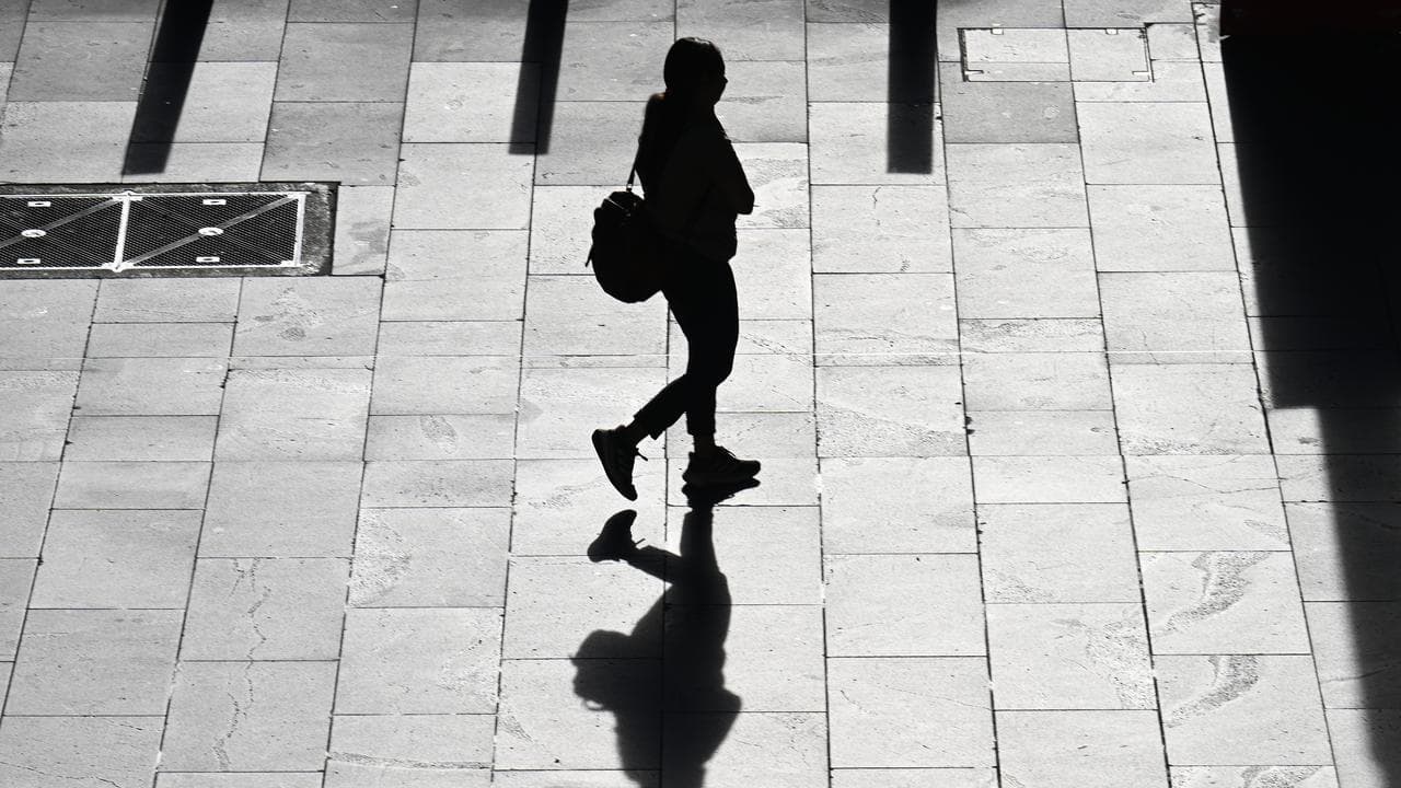 A silhouette of a person on their morning commute