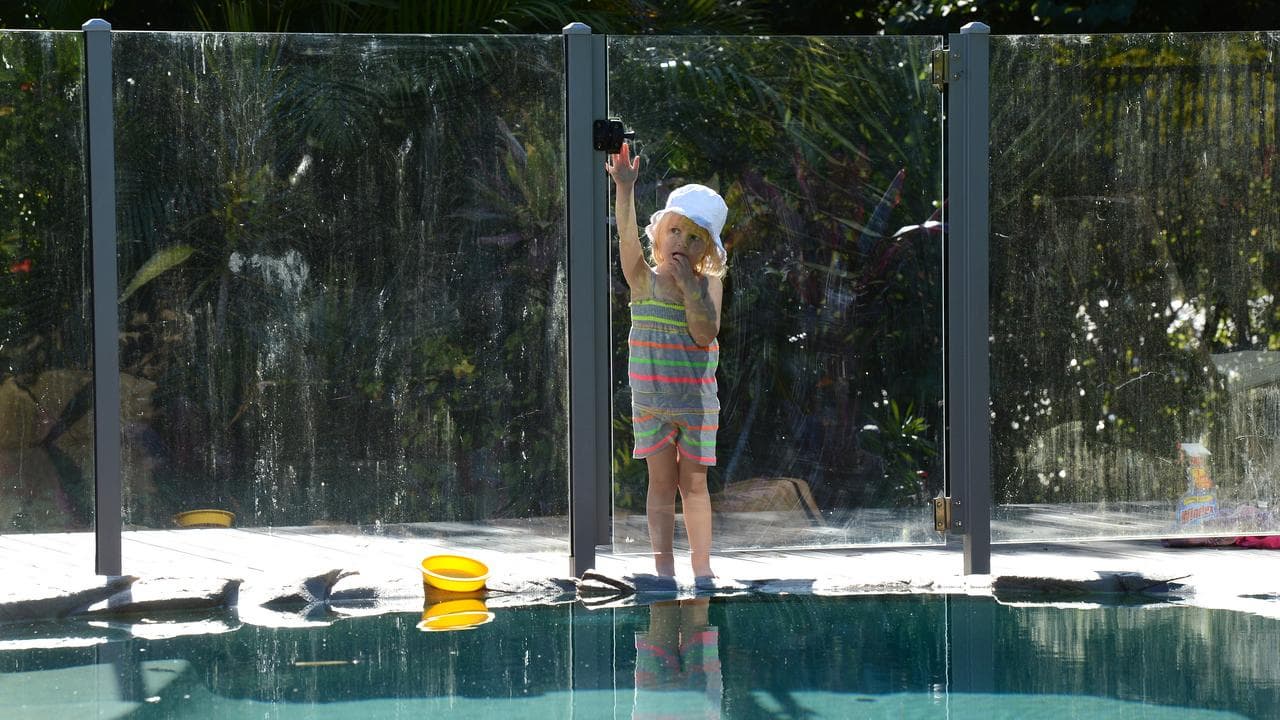 Child at swimmin pool fence
