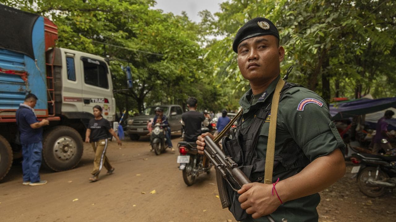 Cambodian policeman protects a supply truck