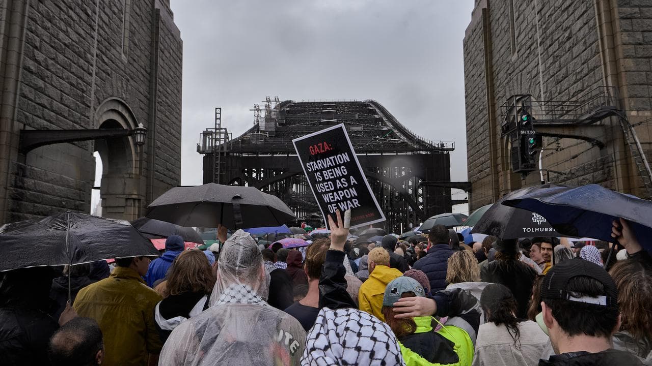Crowd walks over bridge