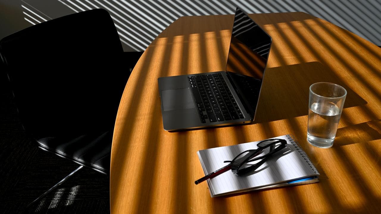 A laptop is seen on a work desk