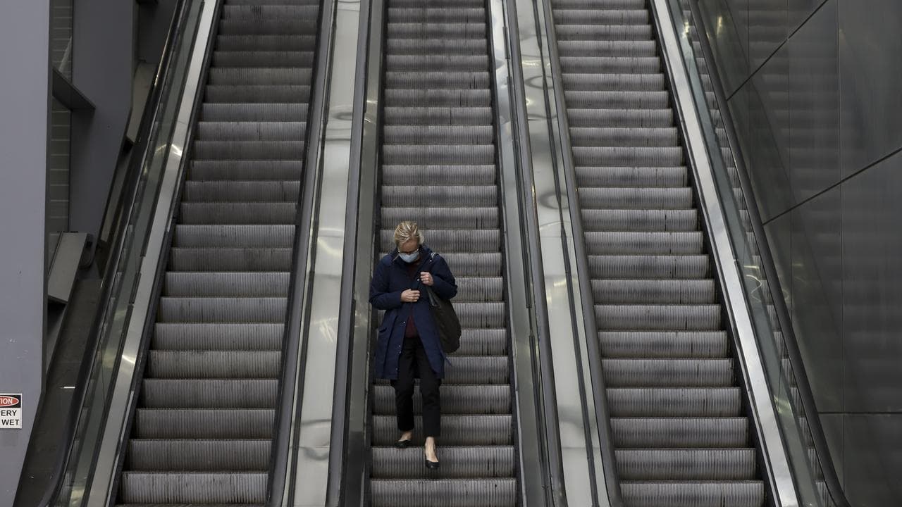 Women rides escalator