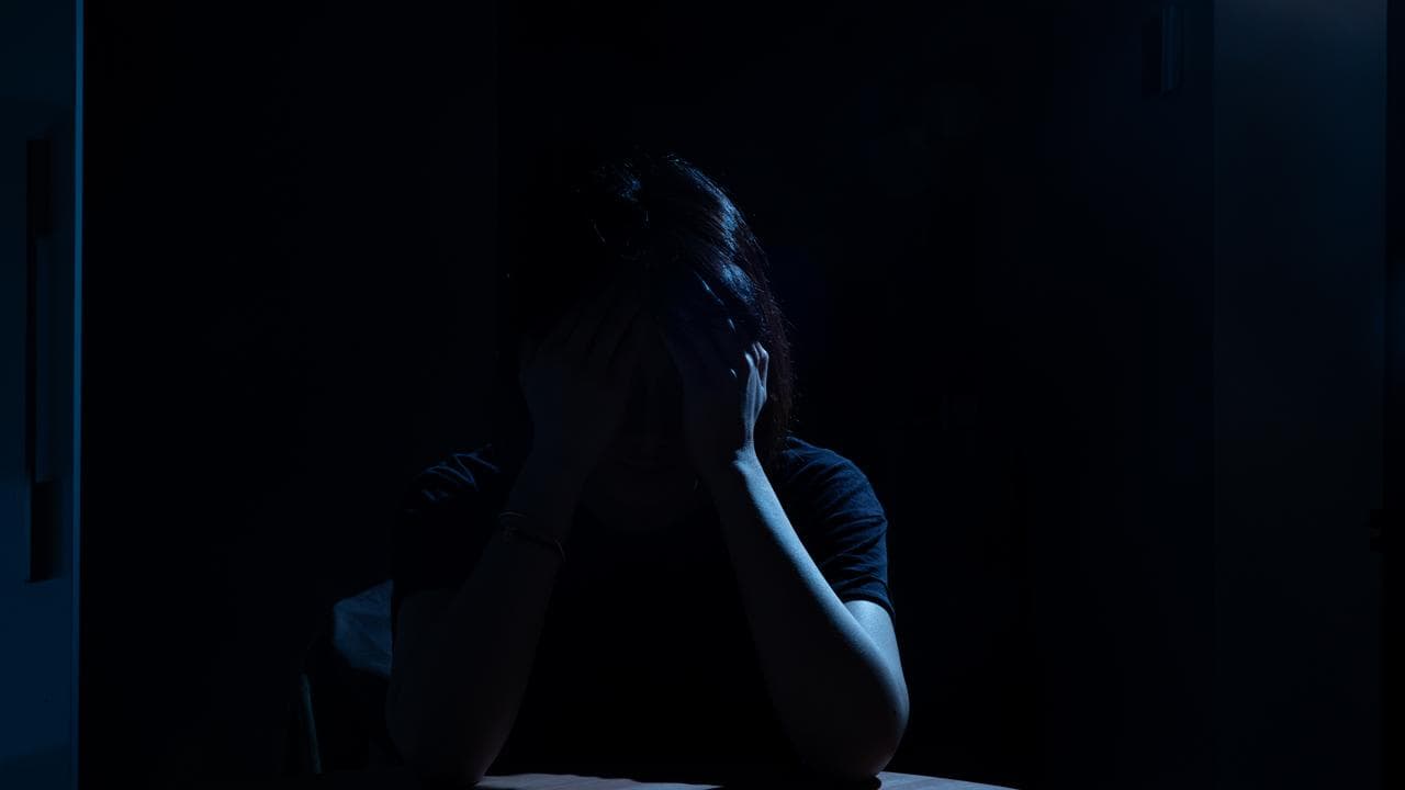 A person poses for a photograph