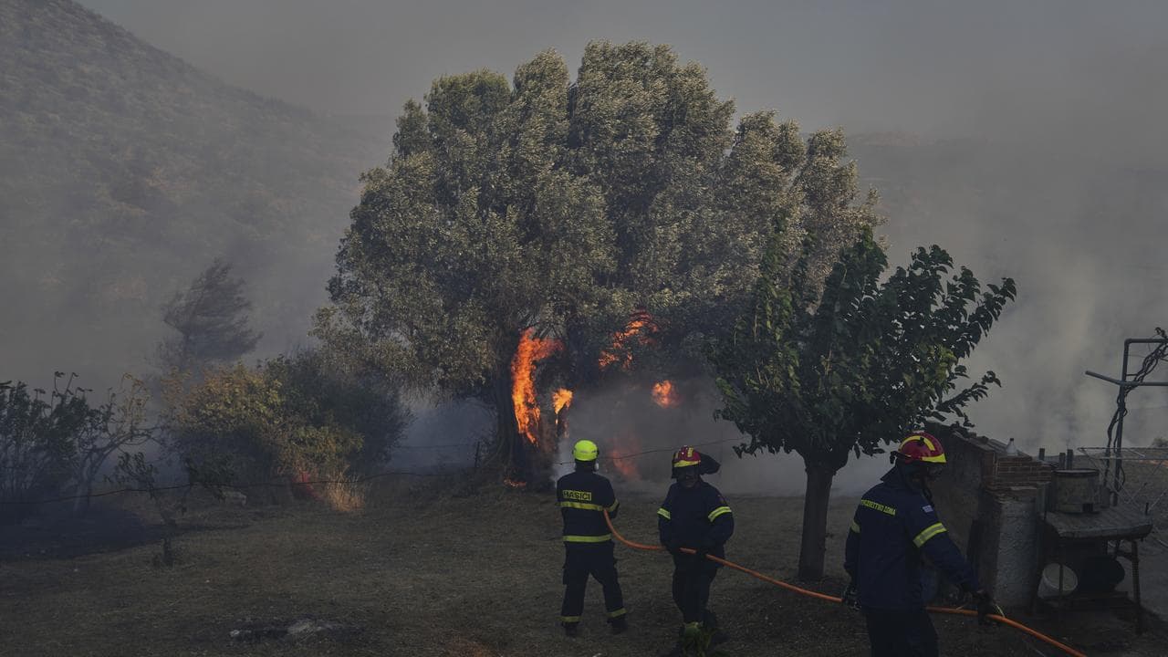 Firefighters try to put out a fire in Kerate