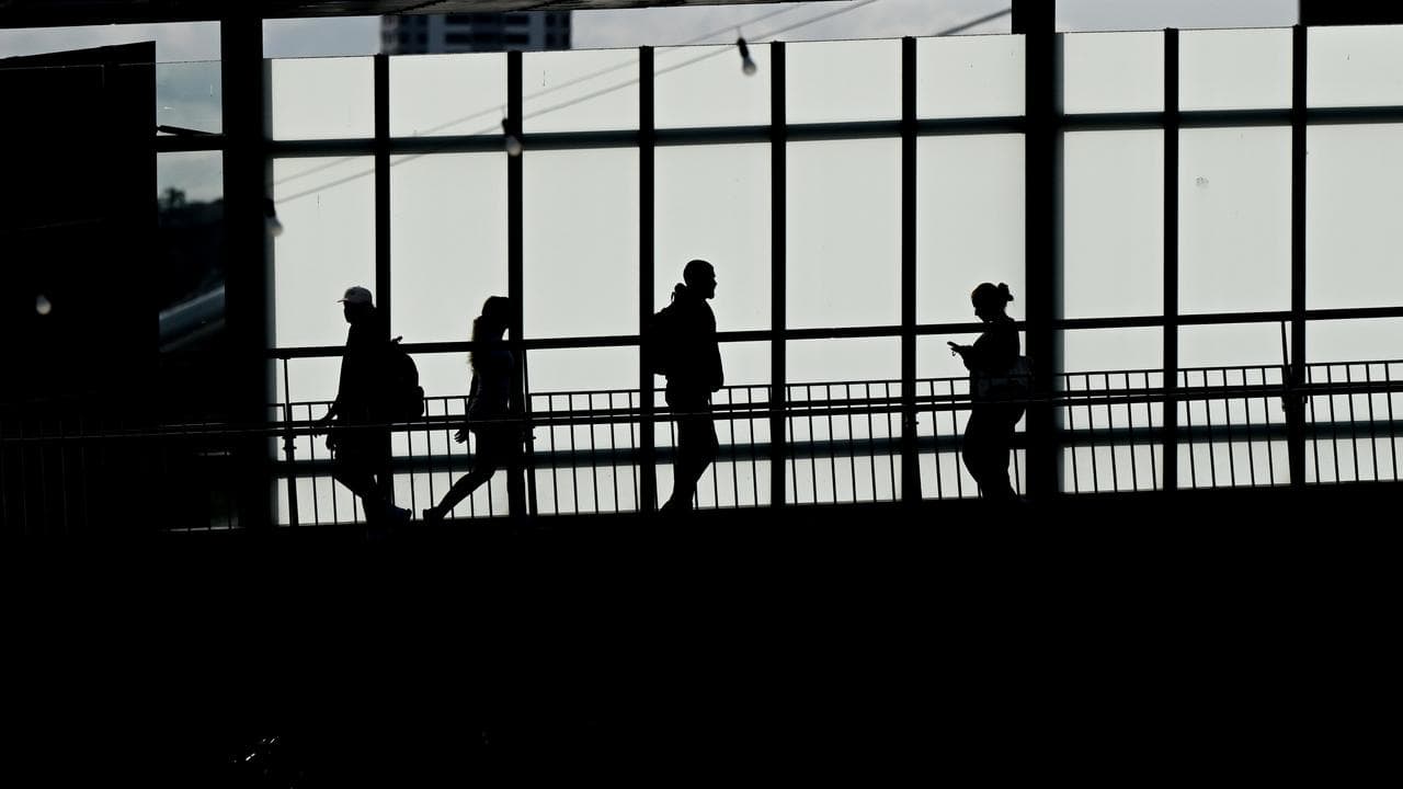 Pedestrians are seen crossing the Goodwill Bridge in Brisbane