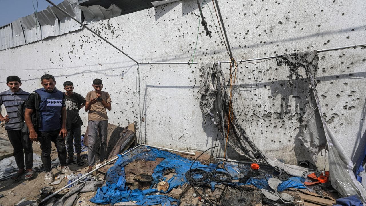Palestinians inspect the destroyed tent