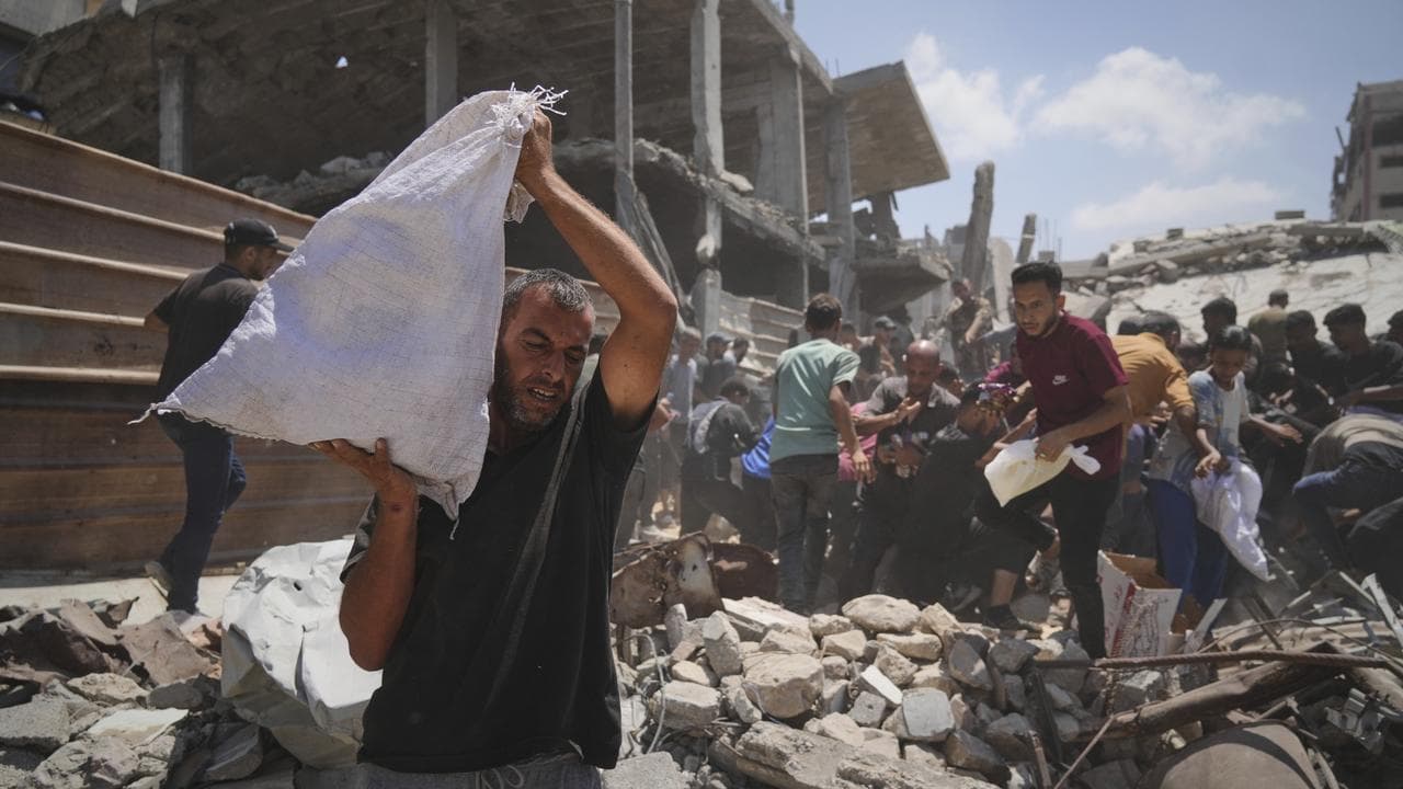 Palestinians collect aid airdropped into Gaza City