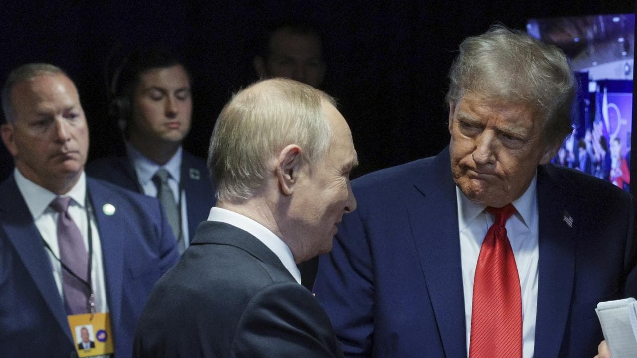 Donald Trump, shakes hands with Russian President Vladimir Putin