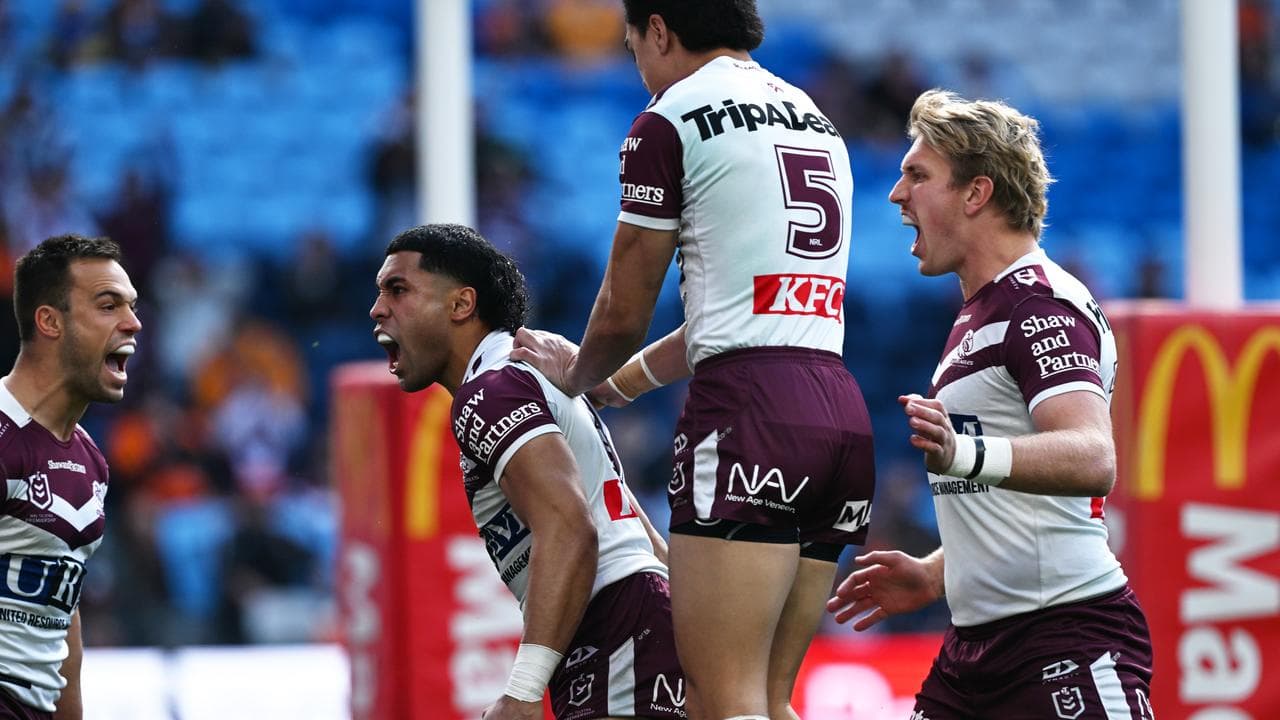 Manly teammates rush to congratulate Tolutau Koula