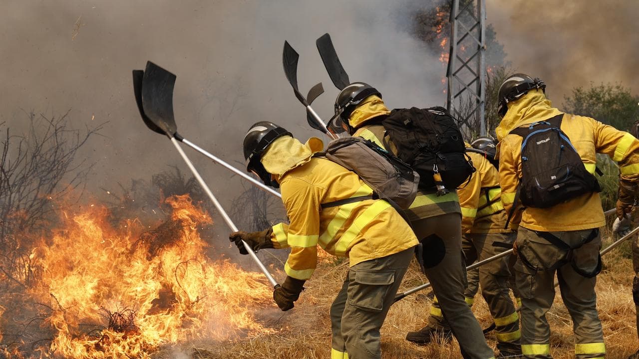 Firefighters battle a wildfire in Veiga das Meas, northwestern Spain