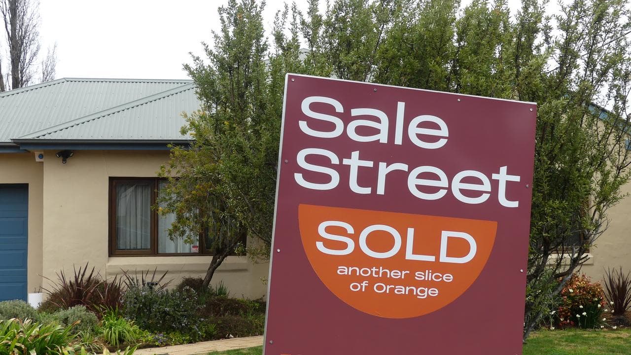 A sold sign is displayed outside a house in Orange